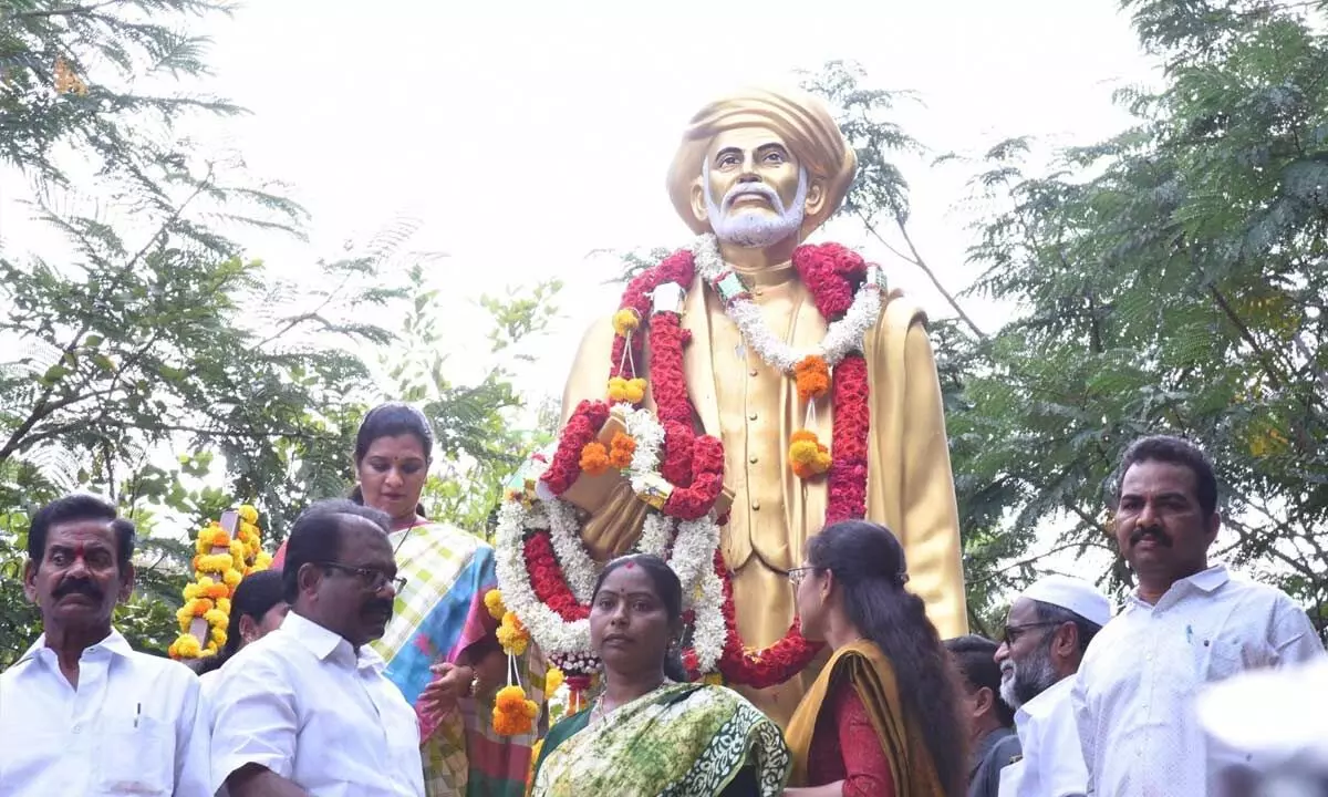 Collector M Gowthami and others after paying floral tributes at the statue of Jyothirao Phule in Anantapur on Tuesday
