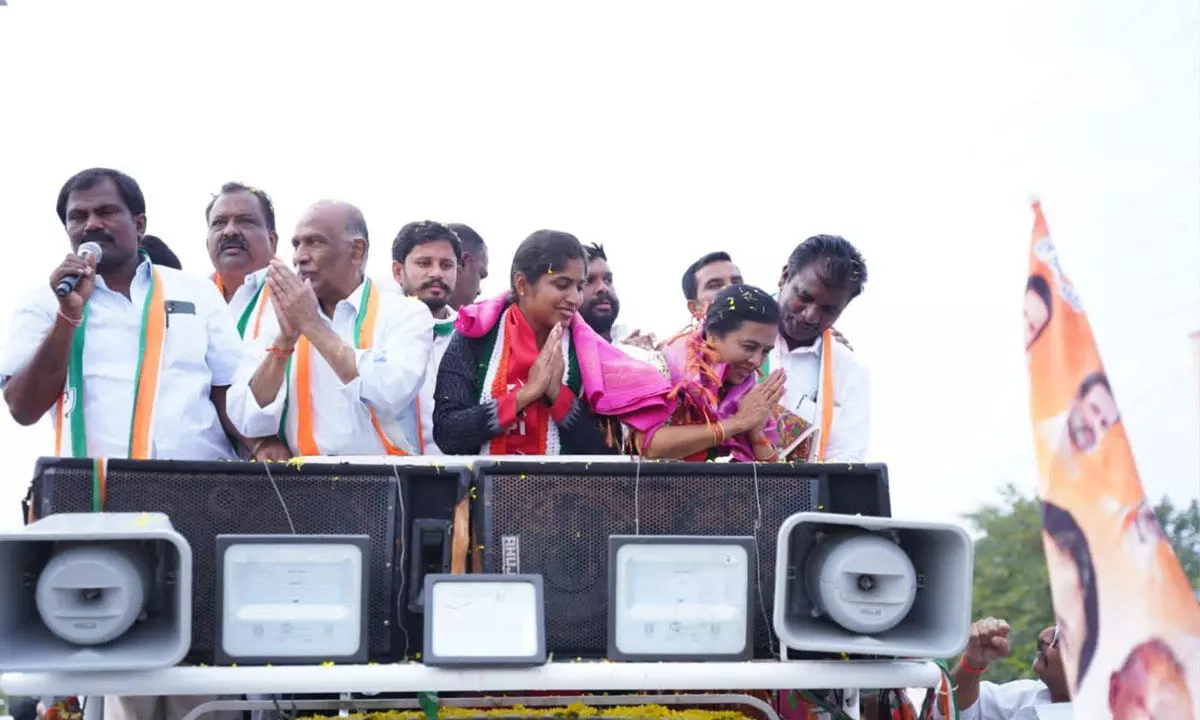 Congress Palakurthi candidate Yashaswini Reddy her in-laws Jhansi and Rajender Reddy greet people during an election rally in Palakurthi on Tuesday