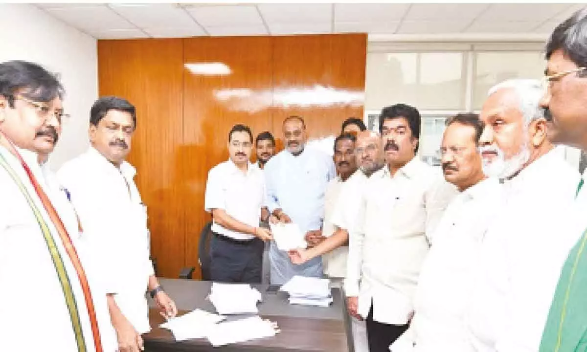 TDP candidate for Chandragiri Assembly constituency Pulivarthy Nani submitting a complaint to Chief Electoral Officer Mukesh Kumar Meena at his office in Amaravati on Thursday. Party leader K Atchannaidu is also seen.