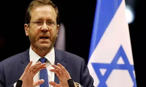 Israeli president honours fallen heroes of Kibbutz Beeri by inscribing Torah Scroll