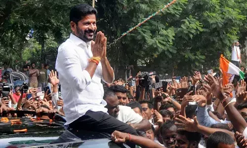 TPCC president Revanth Reddy greets party workers after the Congress’ victory in Assembly polls, in Hyderabad on Sunday. Photo: G Ramesh