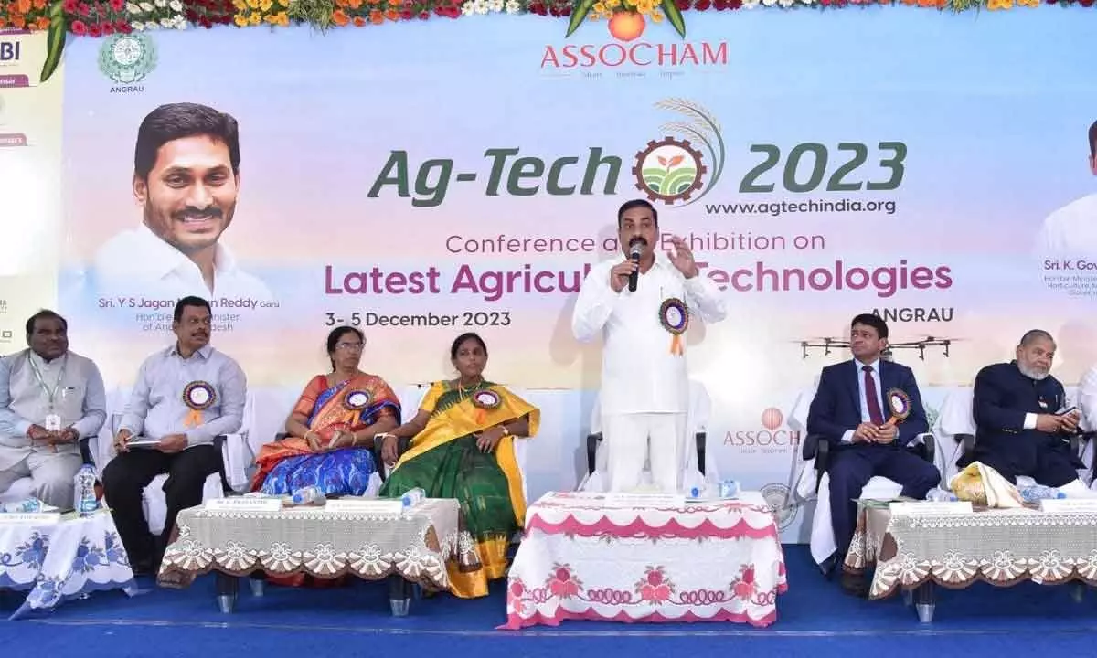 Minister for Agriculture Kakani Govardhan Reddy speaking at a meeting in Guntur on Sunday. ANGRAU Vice-Chancellor Dr Sarada Jayalakshmi is also seen.