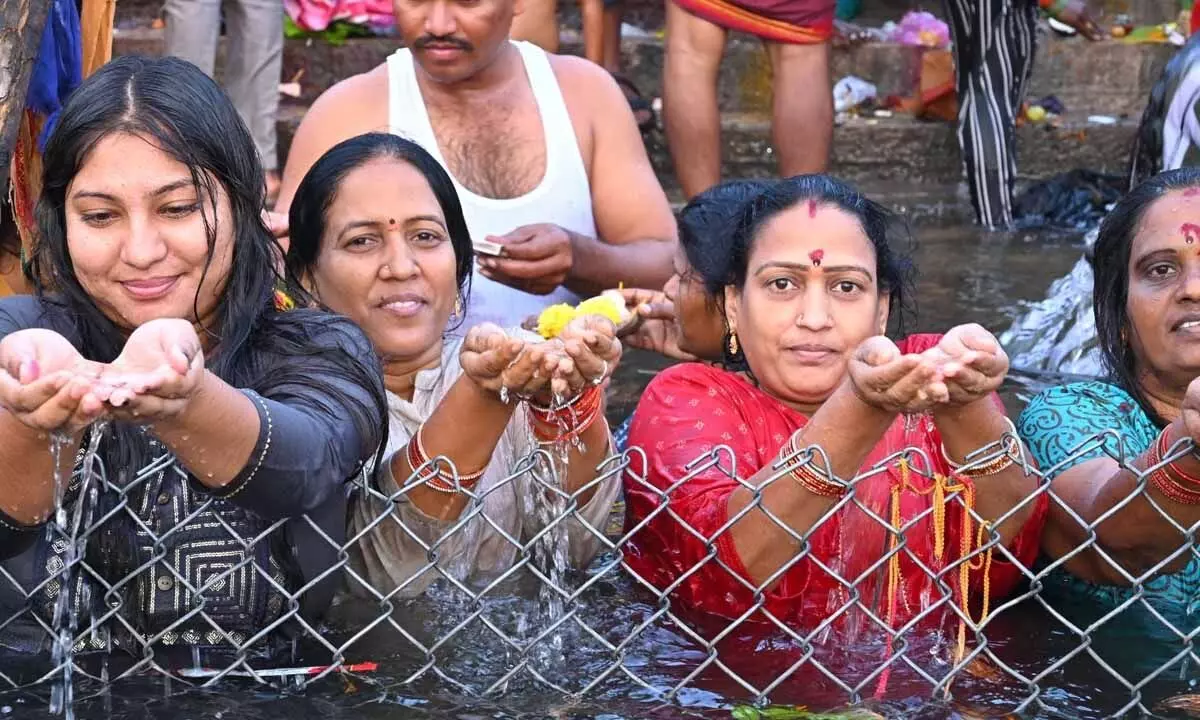 Devotees offering prayers to River Krishnaveni at Pathalaganga in Srisailam on Saturday