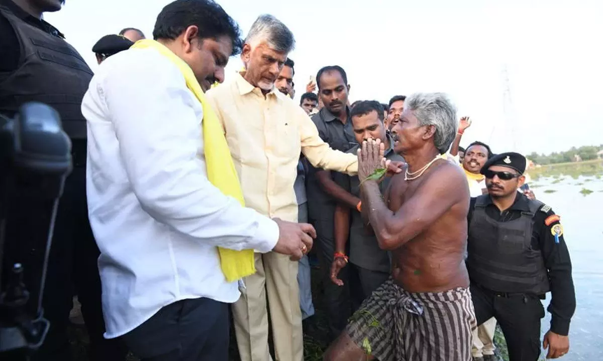 TDP national president and former Chief Minister  N Chandrababu Naidu consoling a farmer who had suffered crop loss due to Cyclone Michaung at Cherukuru village in Parchur mandal in Bapatla district on Friday