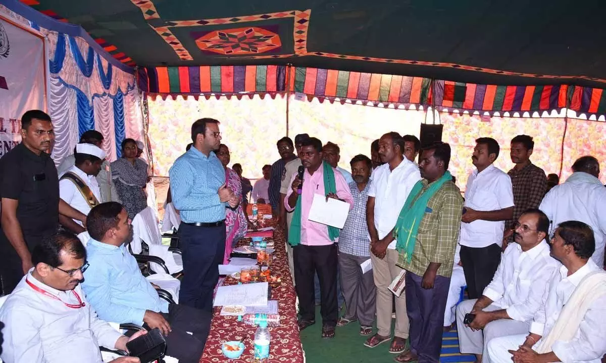 Joint Collector Ketan Garg addressing the farmers over crop damage in Kandukuru village on Saturday