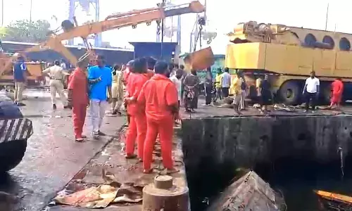 VPA officials launched an exercise of taking out boats submerged at fishing harbour in Visakhapatnam on Monday