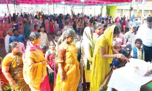 People kissing baby Jesus at St Theresa Church in Ongole on Monday