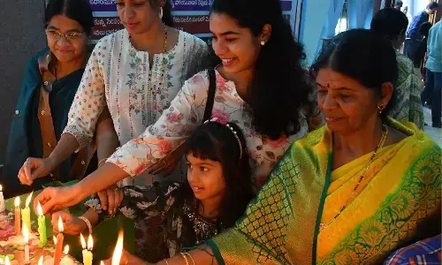 People lighting candle on the occasion of Christmas at St Paul’s Cathedral church in Vijayawada on Monday