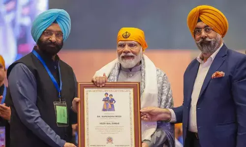 Prime Minister Narendra Modi being felicitated by the Delhi Sikh Gurdwara Management Committee (DSGMC) during Veer Baal Diwas programme commemorating the martyrdom of two sons of Guru Gobind Singh, at Bharat Mandapam, in New Delhi on Tuesday