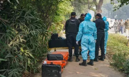NSG Commandos with the forensic officials during an investigation near the Israeli embassy after a reported low intensity blast nearby, in New Delhi on Wednesday. The Delhi Police has intensified its probe into a low intensity blast that occurred near the Israel Embassy here and sources said two youths were caught on camera walking on the road close to the spot shortly before the explosion