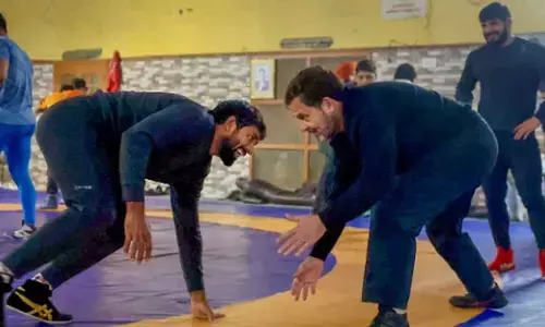 Congress leader Rahul Gandhi with wrestler Bajrang Punia and other wrestlers at Chhara village, in Jhajjar district on Wednesday