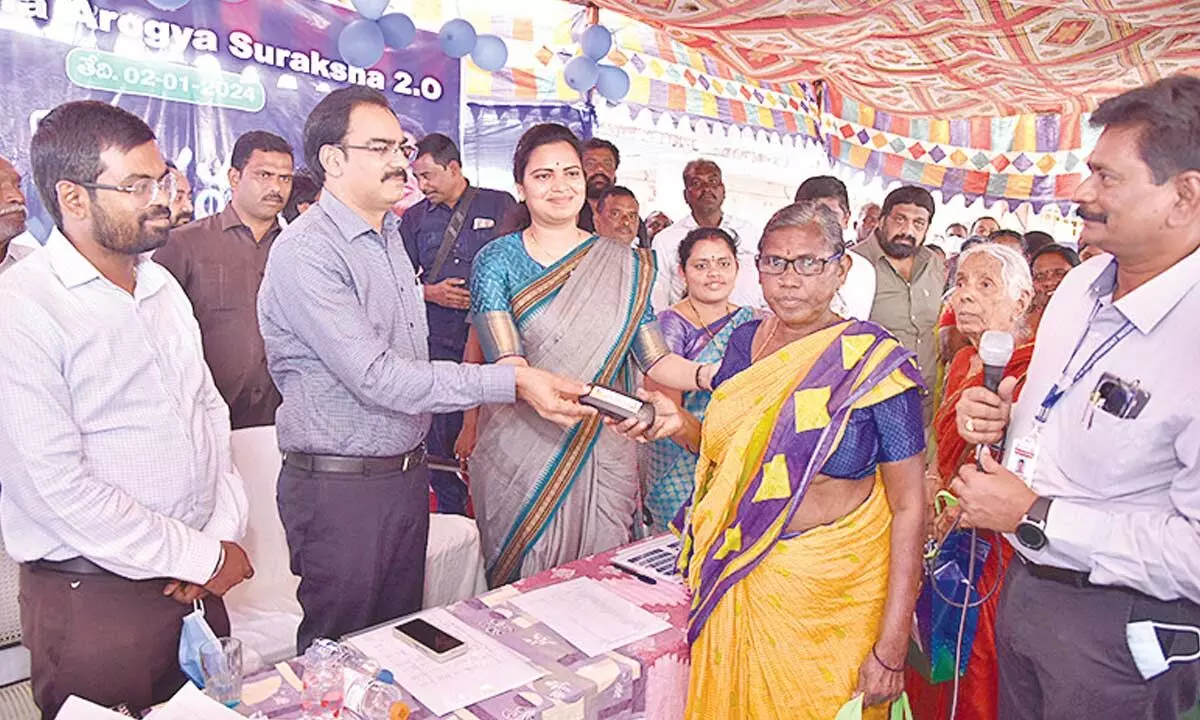 Minister Vidadala Rajini and district collector M Venugopal Reddy distributing medicines to patients at Jagananna Arogya Suraksha 2.0 programme at China Palakaluru on Tuesday