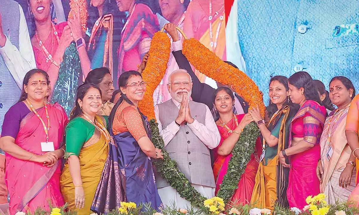 Prime Minister Narendra Modi being garlanded during a BJP-organised womens convention Sthree Shakthi Modikkoppam (Empowered Women with Modi), in Thrissur on Wednesday. Rajya Sabha MP PT Usha and actor Shobana Chandrakumar Pillai are also seen
