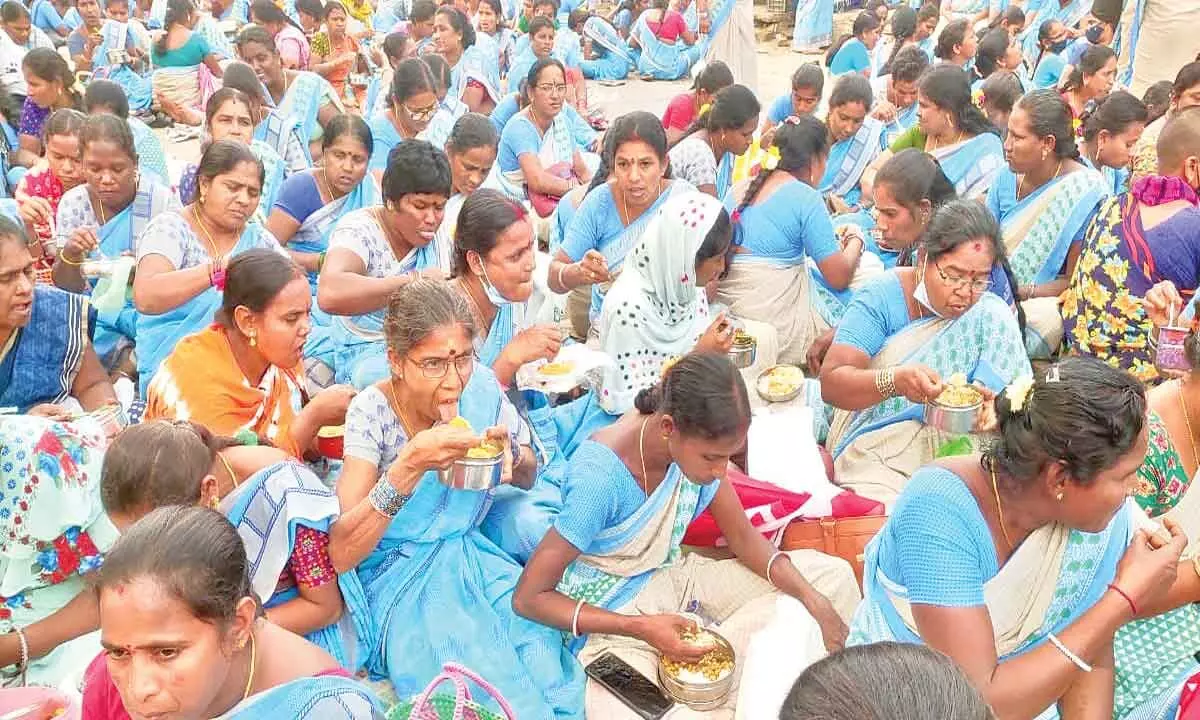 Agitating Anganwadi workers having a lunch on the road as part of their protest in Srikakulam city on Thursday