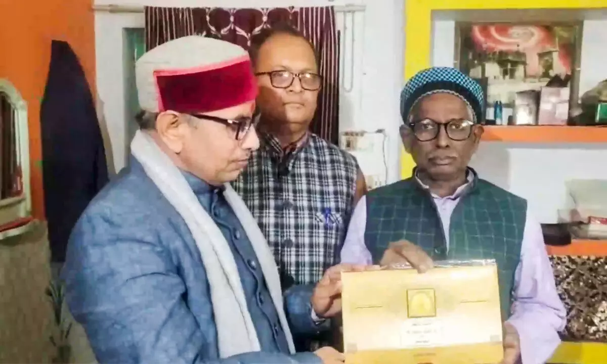 Iqbal Ansari, a litigant in the Ramjanmabhoomi-Babri Masjid case, receives an invitation for the Ram temple consecration ceremony, in Ayodhya on Friday
