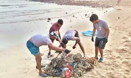 Scuba divers collecting litter at Rushikonda beach in Visakhapatnam on Sunday