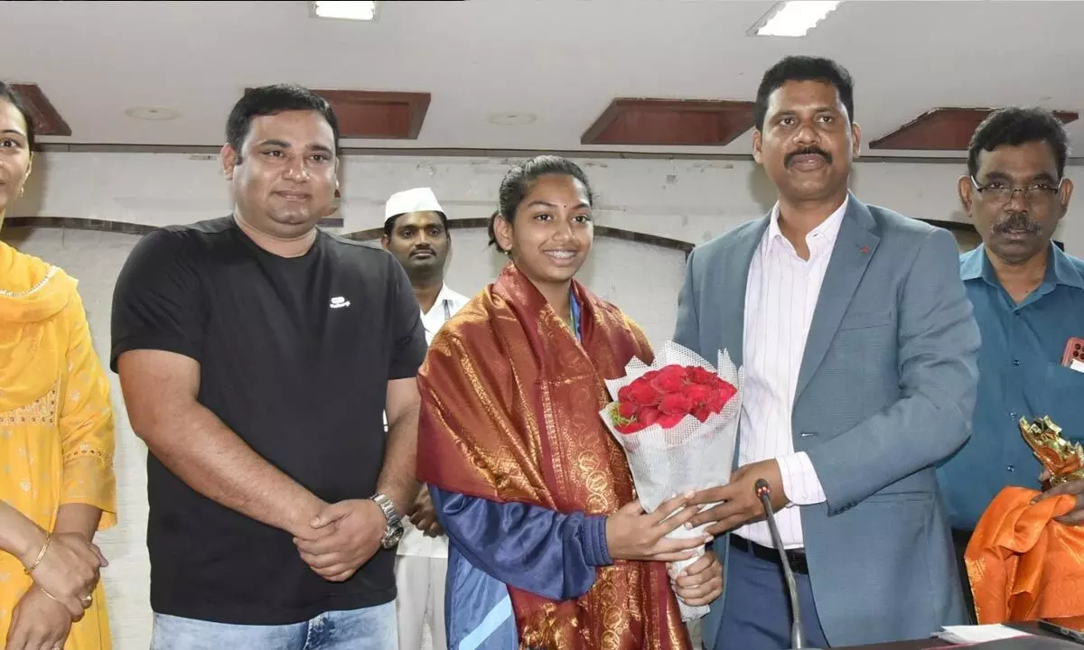 NTR District Collector S Dilli Rao felicitating 12-year-old shooter Tamanyu Sirangini in  Vijayawada on Monday