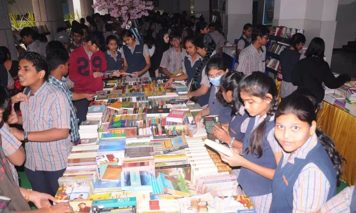 Students taking part in book exhibition at Future Kids Global School in Rajamahendravaram on Wednesday