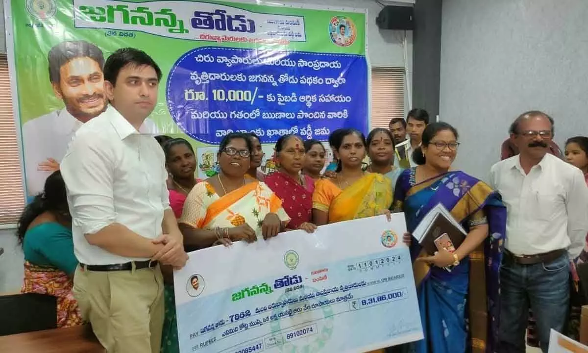 Collector Sumit Kumar and MLA K Bhagya Lakshmi handing over a cheque to beneficiaries in Rajamahendravaram on Thursday