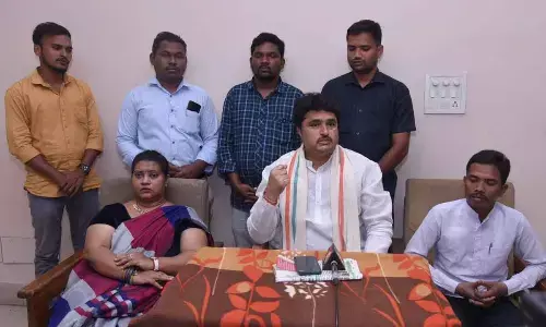 State ST Commission Member Vaditya Shankar Naik speaking at a press conference in Kakinada on Thursday