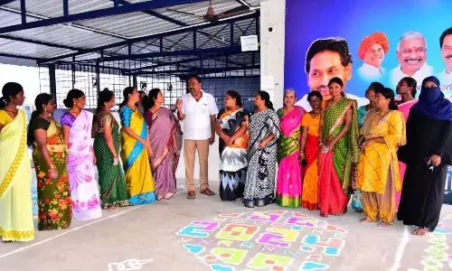 APSRTC Vice-Chairman MC Vijayananda Reddy and judges examining rangoli designs at an event in Chittoor on  Saturday