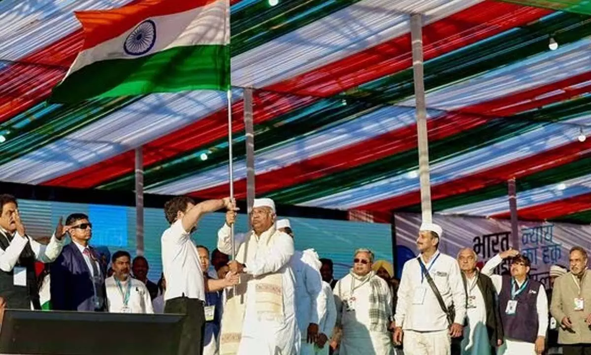 Congress president Mallikarjun Kharge and party leader Rahul Gandhi wave the National Flag during the launch of Bharat Jodo Nyay Yatra, in Thoubal on Sunday