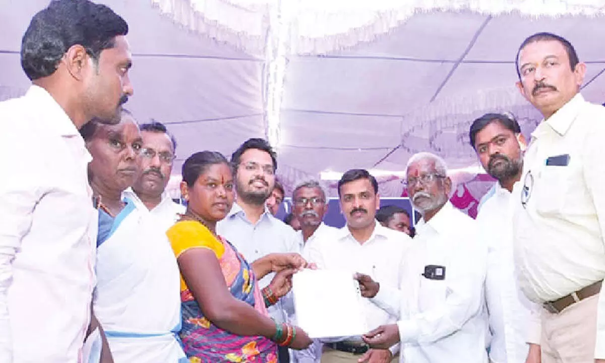 Officials handing over documents to Chenchu beneficiaries at PM JANMAN programme in Yerragondapalem on Monday