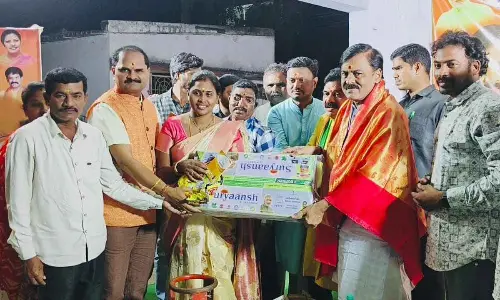 BJP MP GVLNarasimha Rao along with others giving away LPG connections to beneficiaries in Visakhapatnam on Thursday