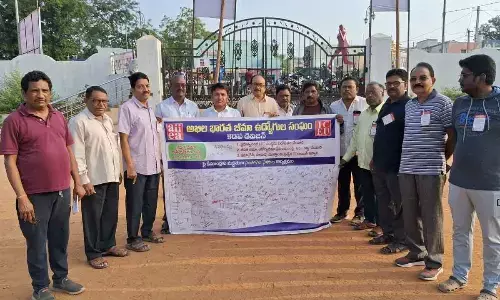 LIC employees conducting ‘signature collection’ programme at Arts College in Kadapa on Friday