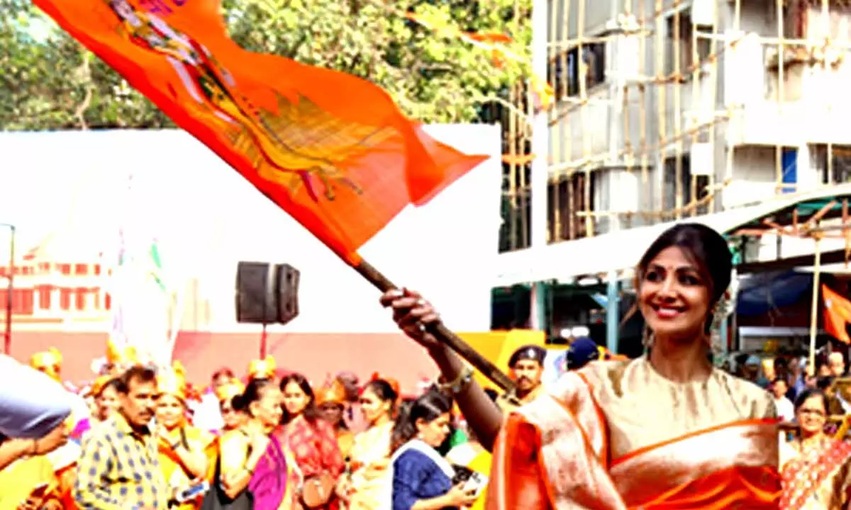 Shilpa waves saffron flag with Lord Rams image at Siddhivinayak temple