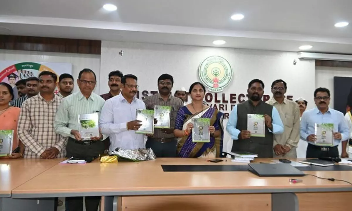 Collector Dr K Madhavi Latha releasing Agriculture Department Officers Association Diary and a book in Rajamahendravaram on Monday