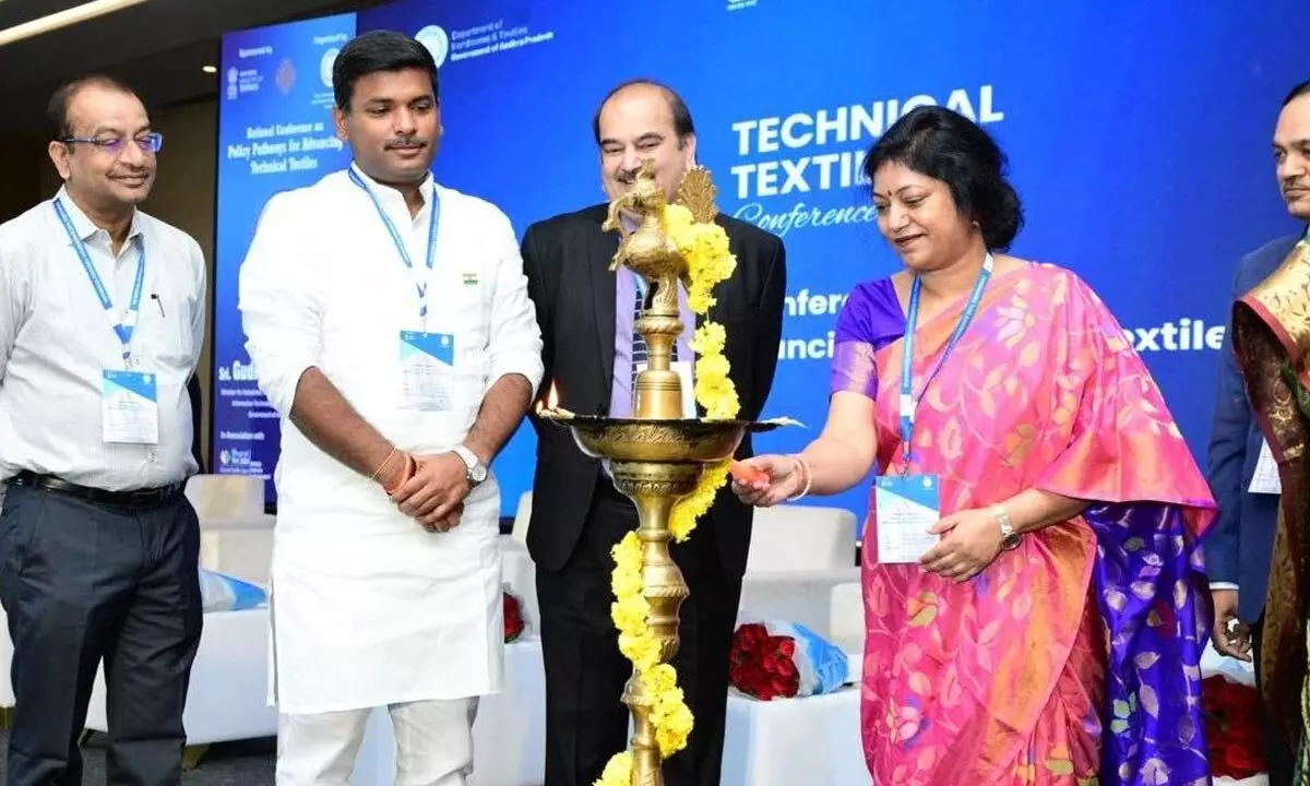 Principal secretary K Sunitha lighting the traditional lamp to mark the inauguration of national conference on textiles in Vijayawada on Monday. Minister for Industries G Amarnath, Commissioner of Handlooms MM Naik and Joint secretary of Union Ministry of Textiles Rajiv Saxena are also seen.