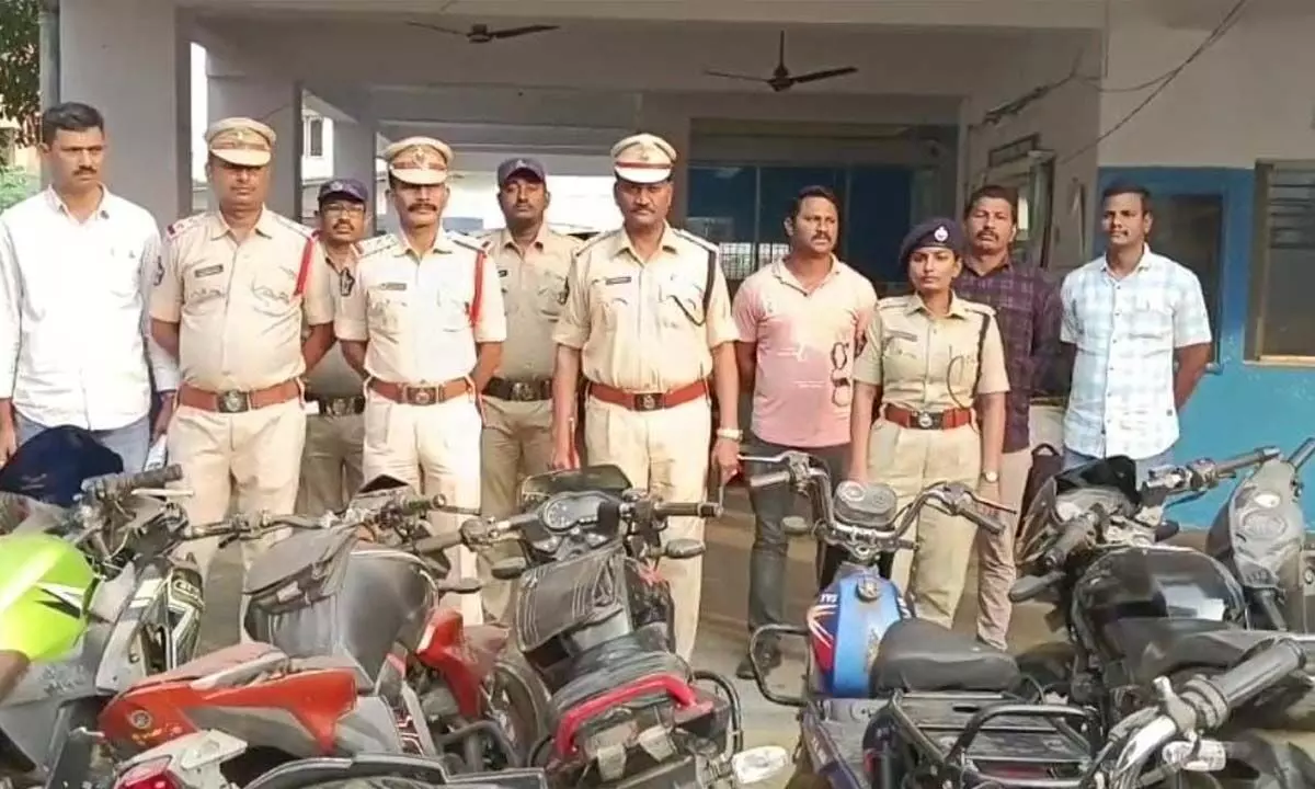 DSP R Govinda Rao with other police personnel and recovered two-wheelers in Vizianagaram on Monday