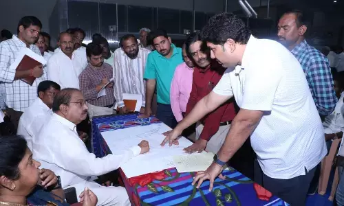 Agriculture Minister Tummala Nageswara Rao enquiring about the progress of Buggapadu Mega Food Park with officials in Sathupalli mandal on Monday