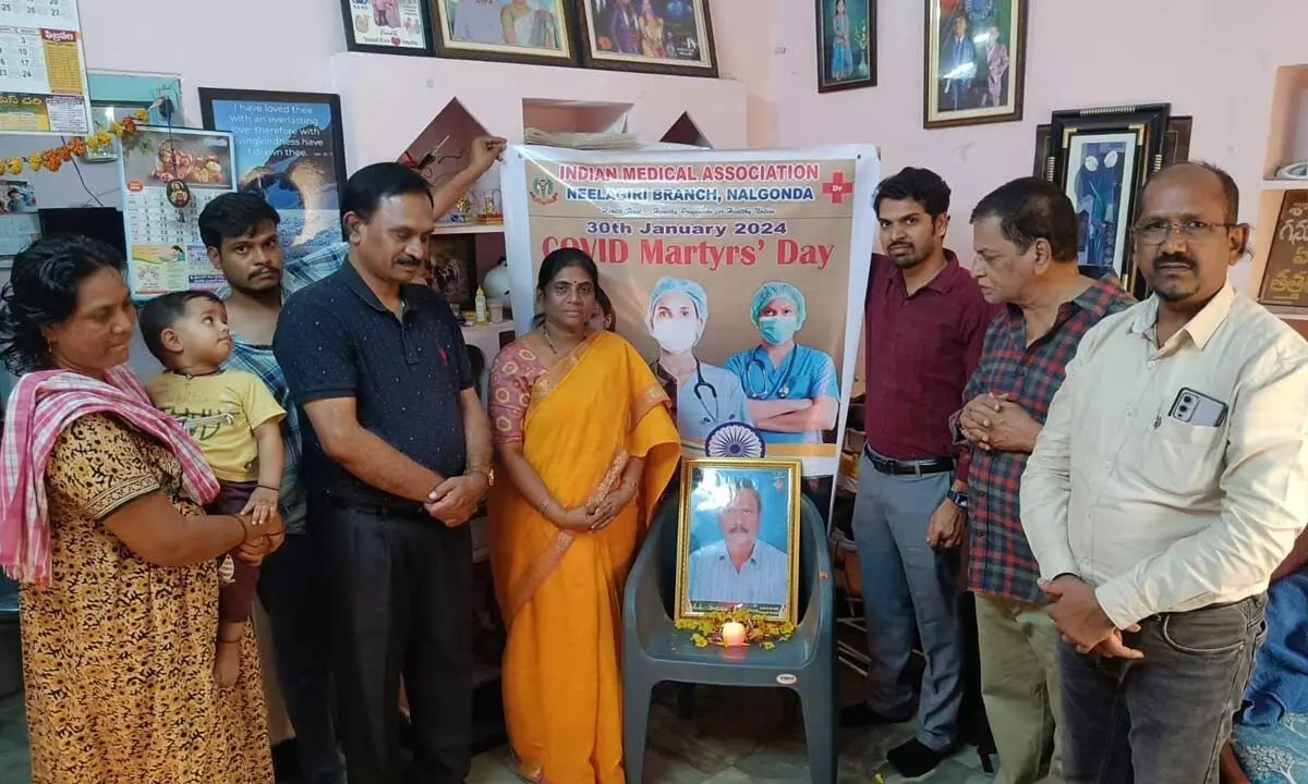 IMA Neelagiri doctors paying tributes to the picture of Dr Abhishek Raju who lost his life while serving patients during Covid-19 pandemic