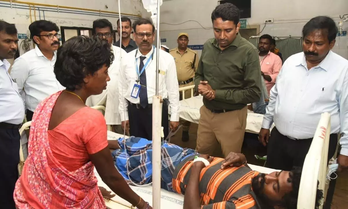 District Collector Dr G Lakshmisha looking at a patient in Ruia hospital on Saturday. DM&HO Dr U Sreehari, Ruia hospital superintendent Dr G Ravi Prabhu and others also seen.