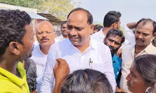 Villagers complaining about the drinking water problem to YSRCP Yerragondapalem in-charge Tatiparthi Chandrasekhar at Chintala Agraharam in Dorna