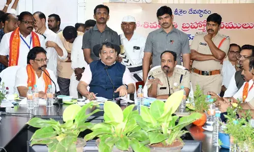 Nandyal district Collector Dr K Srinivasulu addressing a review meeting with temple  staff in Srisailam on Friday