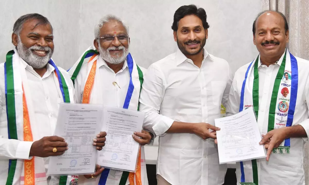 Chief Minister Y S Jagan Mohan Reddy hands over B Forms to G Babu Rao, Y V Subba Reddy and M Raghunatha Reddy to contest Rajya Sabha elections at his camp office in Tadepalli on Monday