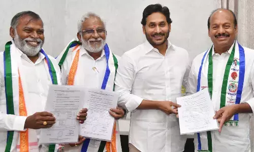 Chief Minister Y S Jagan Mohan Reddy hands over B Forms to G Babu Rao, Y V Subba Reddy and M Raghunatha Reddy to contest Rajya Sabha elections at his camp office in Tadepalli on Monday