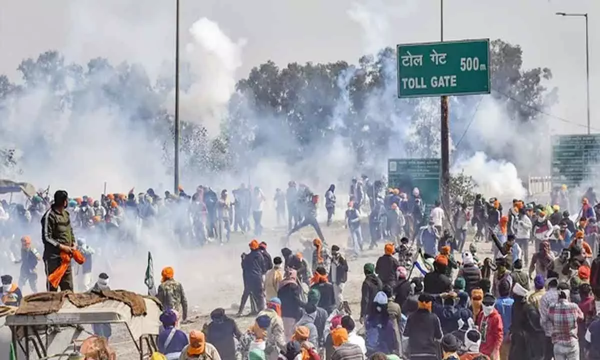Tear gas shells lobbed, farmers stay put