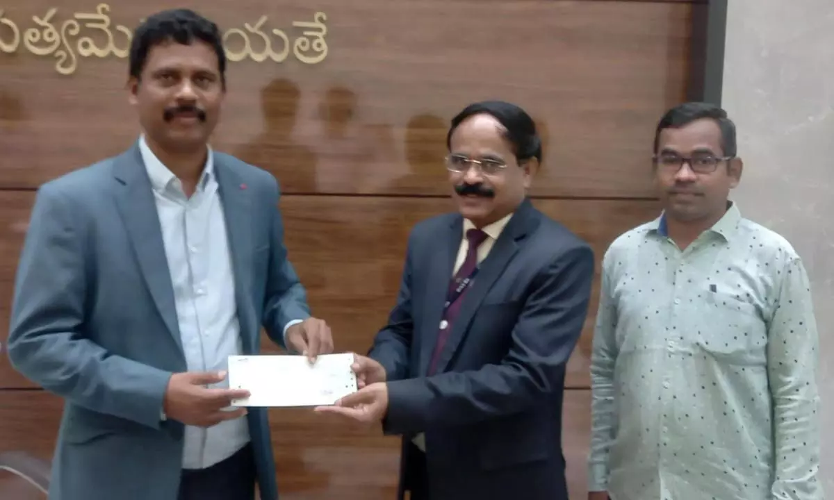 Collector S Dilli Rao receiving donation for Armed Forces Flag Day fund from officials of Canara Bank on Tuesday