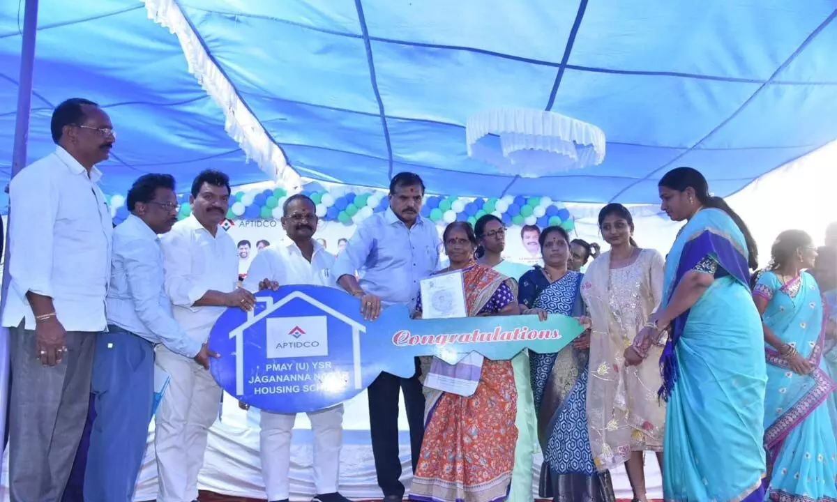 Education minister Botcha Satyandarayana handing over keys to the beneficiaries of TIDCO houses in Vizianagaram on Tuesday
