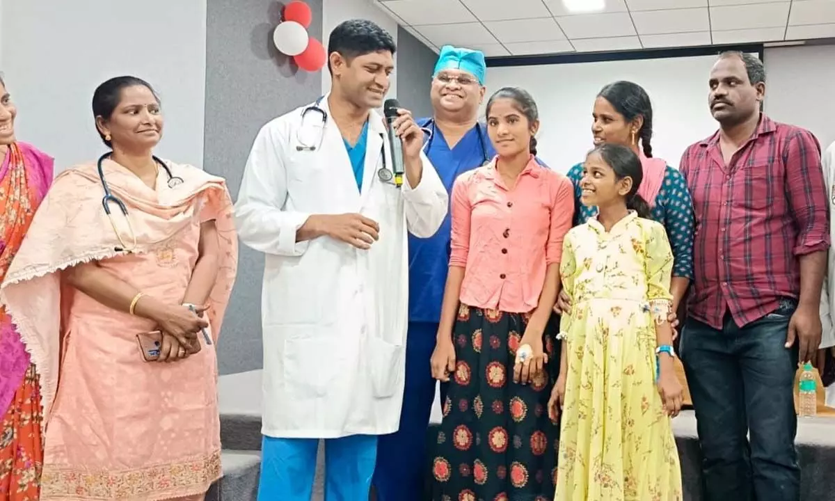 Dr K Tirumala Prasad and other doctors with the two girls who underwent advanced surgery for heart ailments at  Tirumala Medicover hospital on Monday
