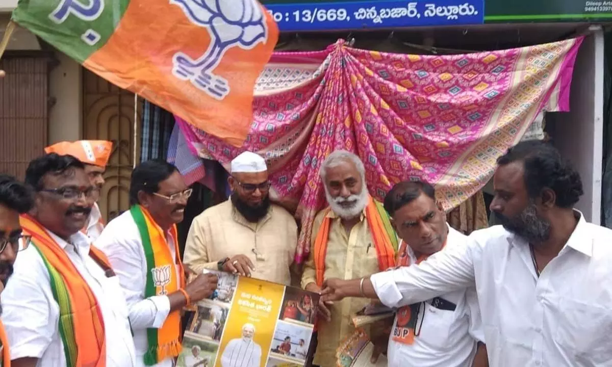 BJP leaders distributing publicity material with details of Central government schemes to the people at Chinna Bazar in Nellore city as part of a Praja Poru programme on Tuesday