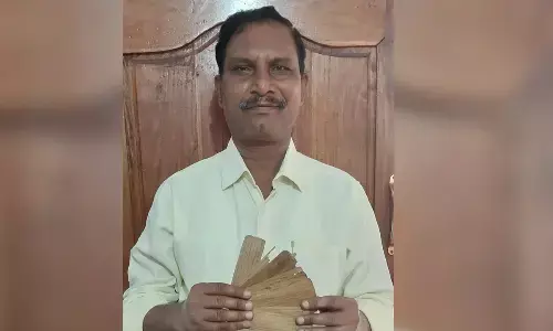 Historian MyNaa Swamy showing palm leaves  manuscript found in Kadiri