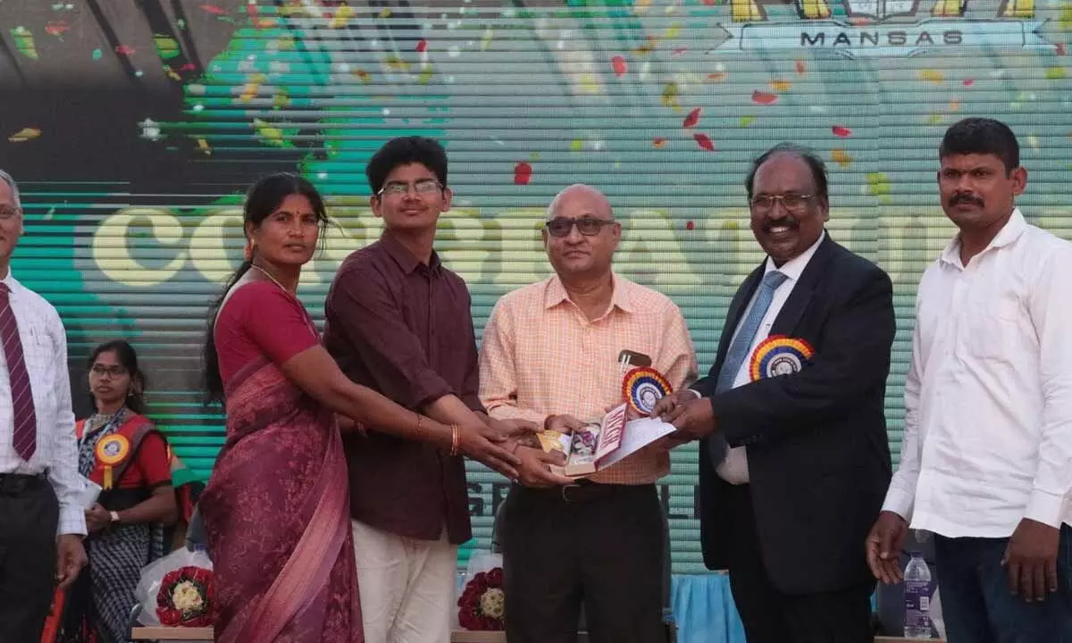 Student academic topper receiving gold medal from trade experts in Vizianagaram on Saturday