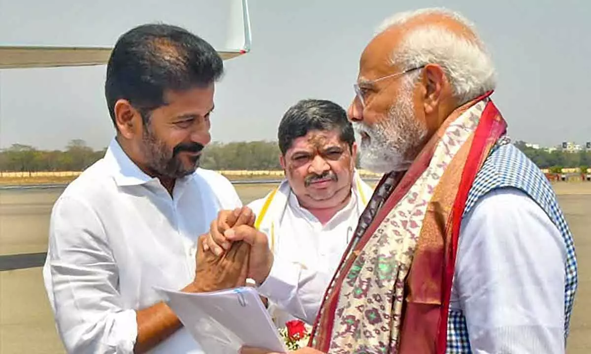 Telangana Chief Minister A Revanth Reddy bids farewell to Prime Minister Narendra Modi who leaves for Odisha after his two-day Telangana tour, at the Begumpet Airport, in Hyderabad on Tuesday