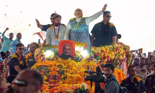 Prime Minister Narendra Modi waves at supporters as he arrives for a public meeting at Patancheru, in Sangareddy district on Tuesday