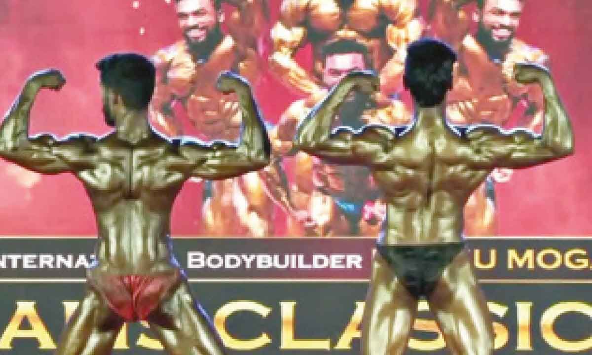 Download A Man Posing For A Bodybuilding Competition | Wallpapers.com